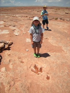 Toby, posing behind a fossilized dino print.